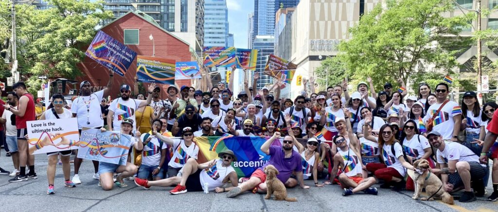 A large group of people celebrate at a Pride festival