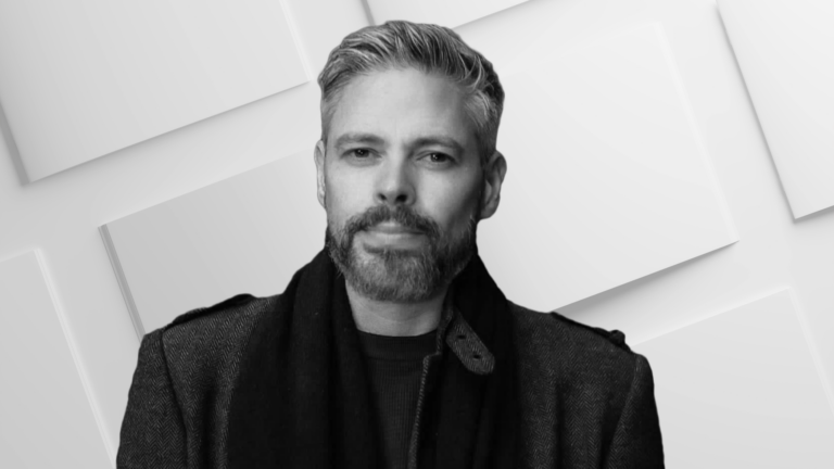 Portrait shot of a man with a beard with a background of empty book pages