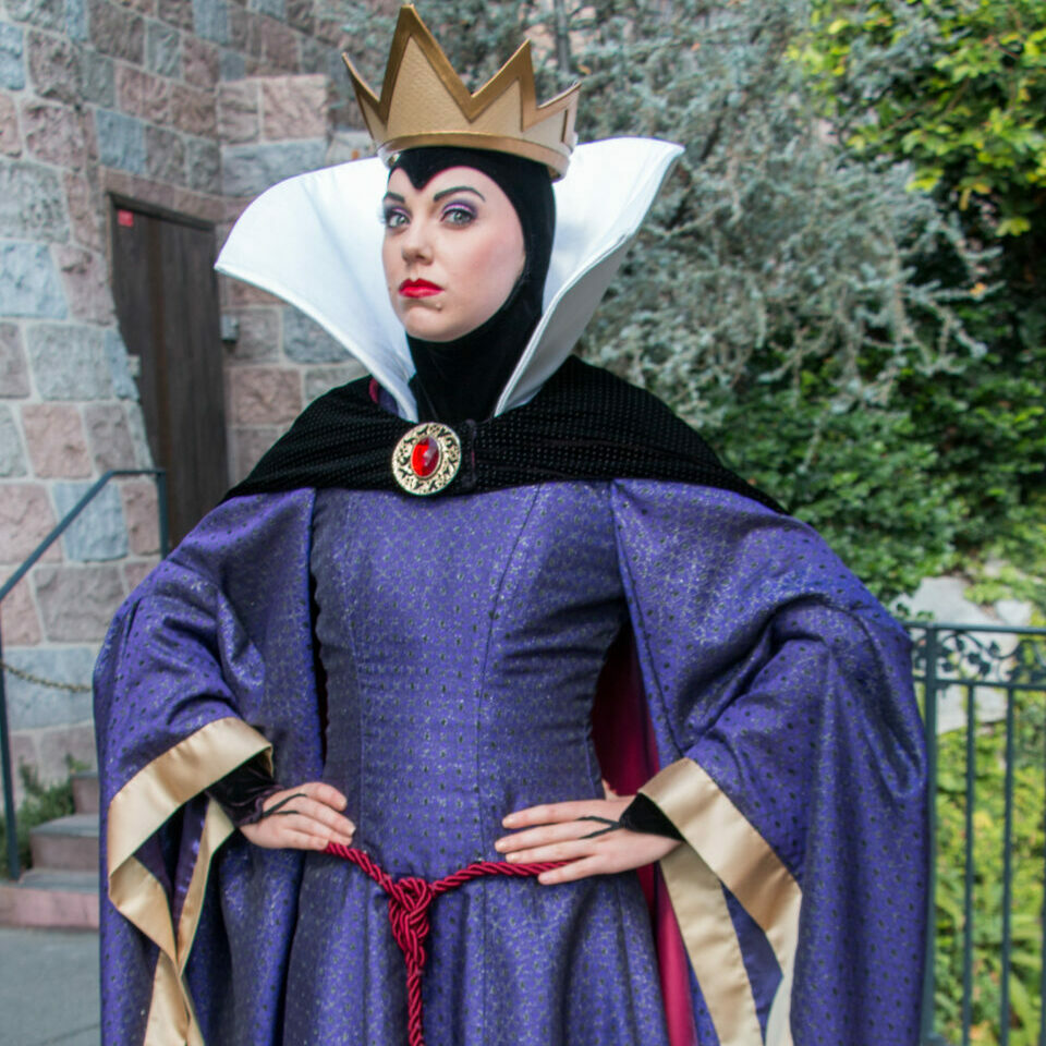 The Evil Queen striking a pose near Snow White's Wishing Well in Disneyland.