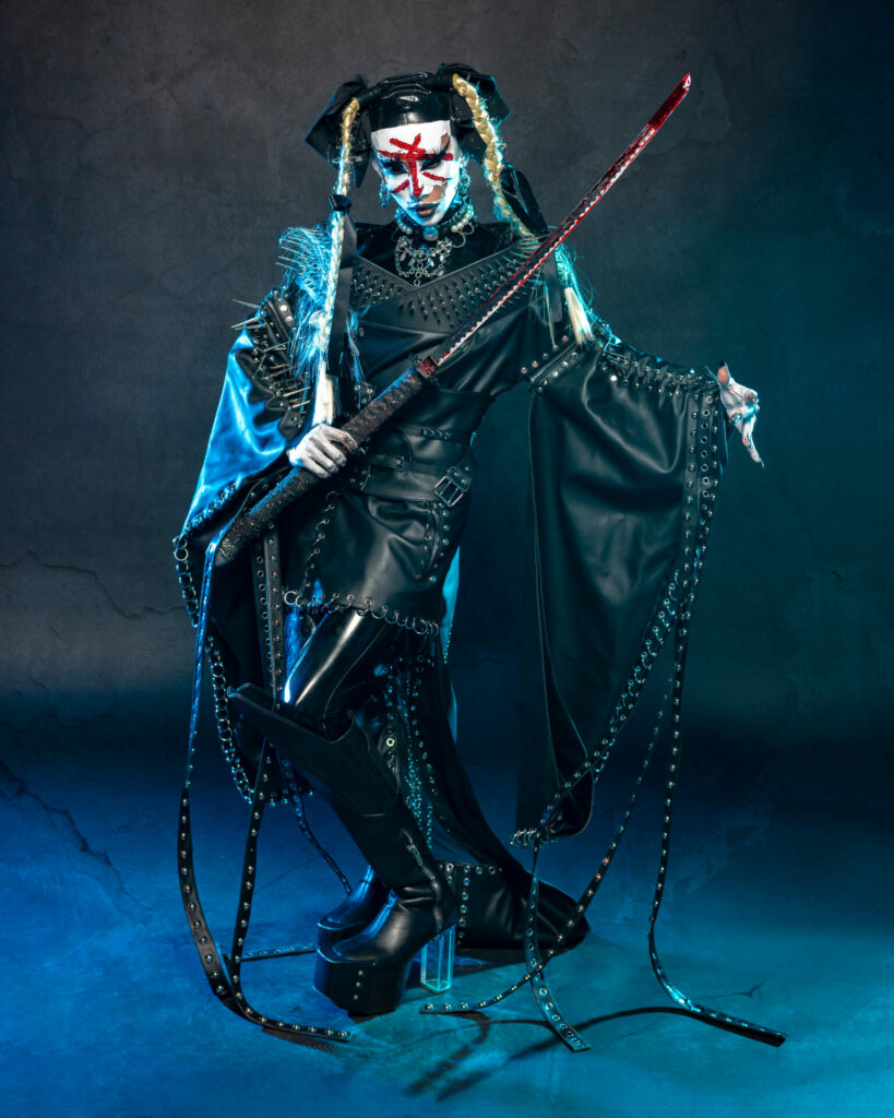 Drag queen dress in black leather Asian-inspired outfit with a Japanese sword