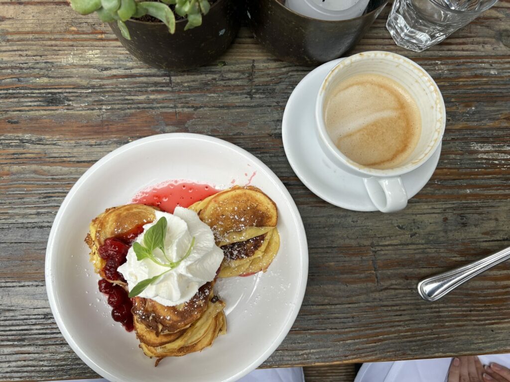 Swedish mini pancakes with seasonal fruit compote and whipped cream