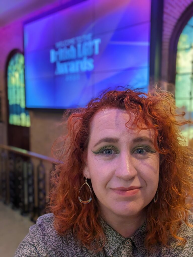 Profile shot of a person with red curly hair