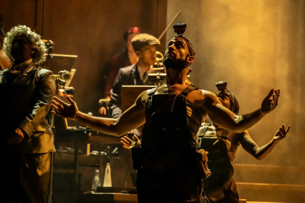 Cast of Hadestown perform onstage
