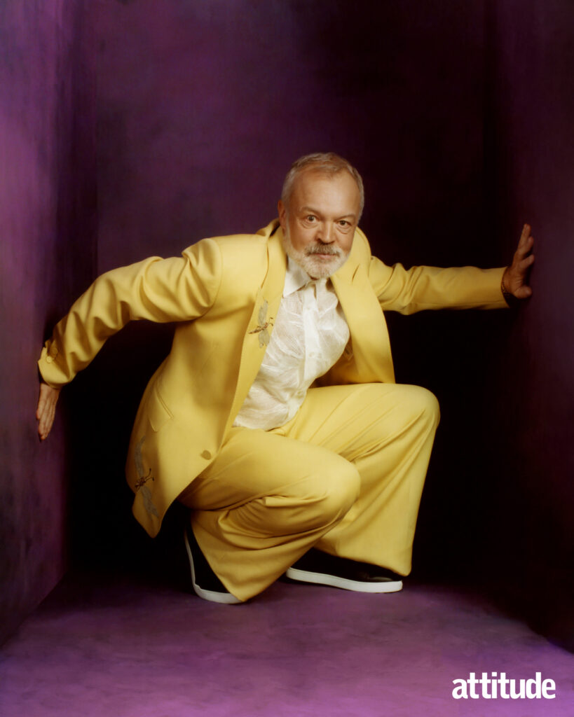 Graham crouching in a yellow suit