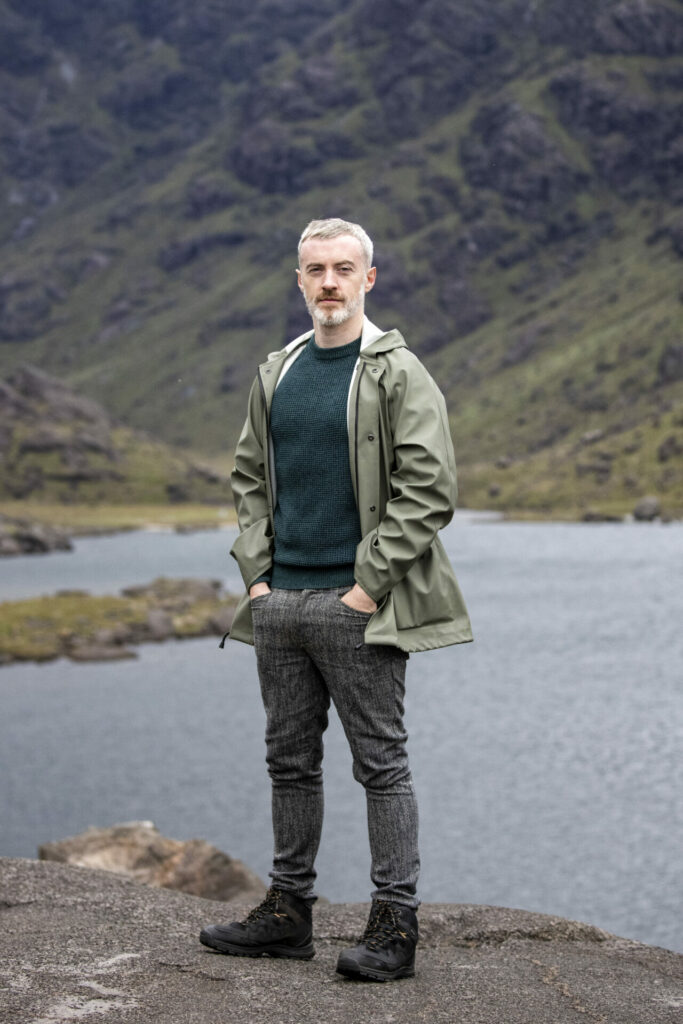 A man stands by a Loch on the Isle of Skye 