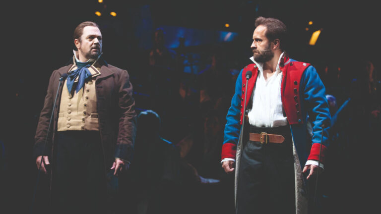 Cast image from Les Miserables showing two men onstage