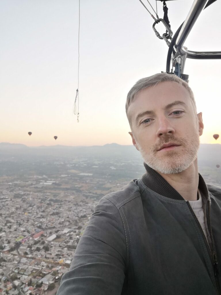 A man riding in a hot air balloon