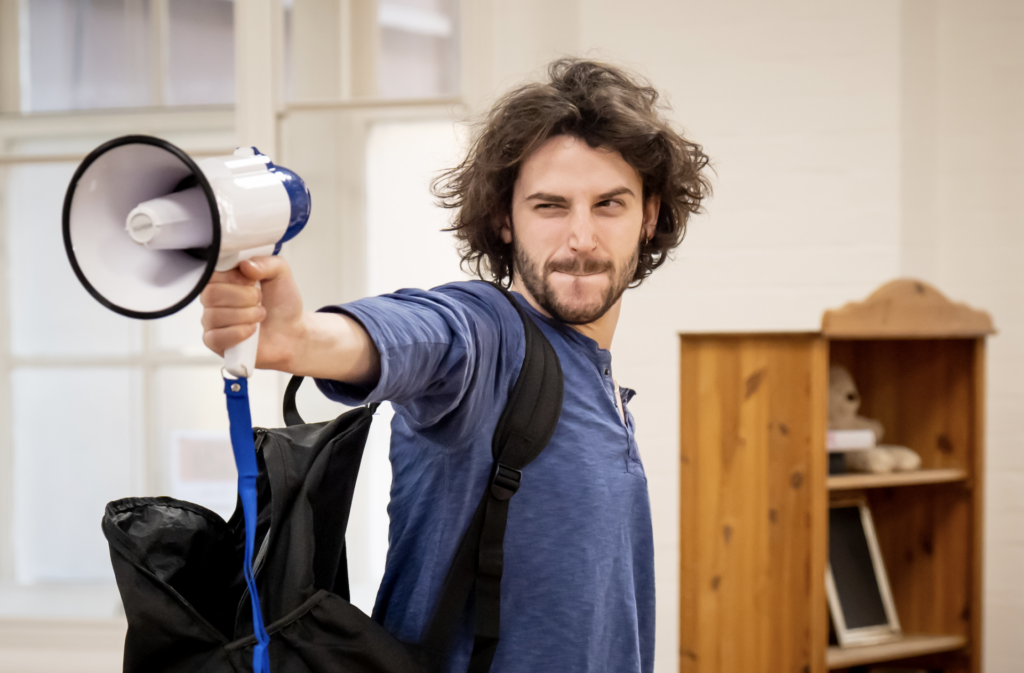 Adam Bregman rehearsing for Starter For 10 holding a gramophone (Image: Bristol Old Vic)