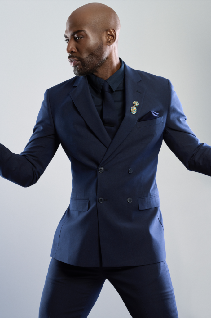 A portrait-shaped picture of Karamo in a blue suit