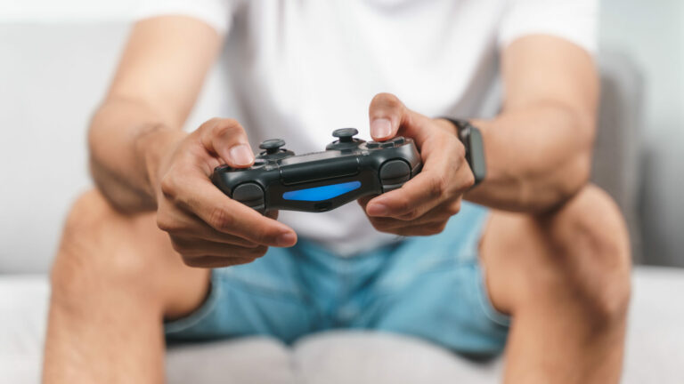 Close up a man holding a gaming controller