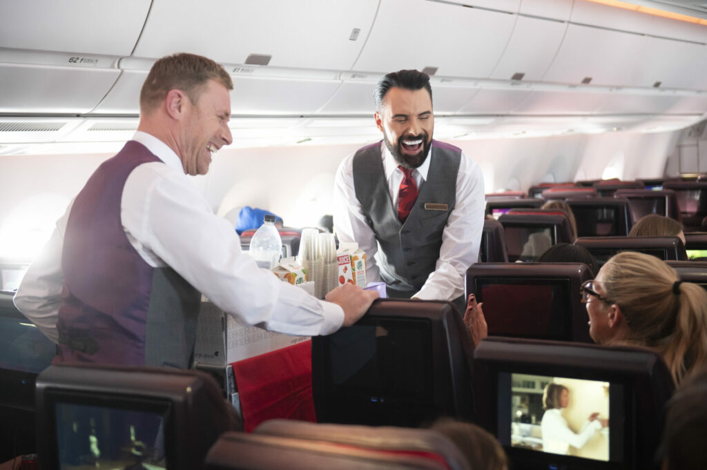 Rylan Clarke serves drinks on a Virgin Atlantic flight