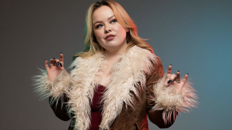 Nicola Coughlan in a fur trim coat as Big Mood's Maggie (Image: Channel 4)