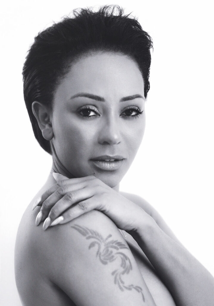 A portrait shot of Mel B in black and white