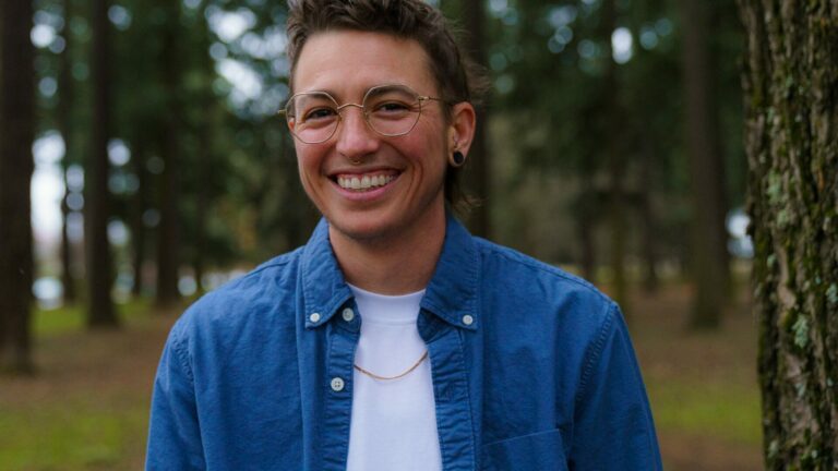 A person smiles into the camera