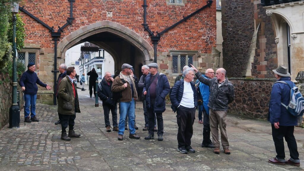 A group of men on a walk in an old town