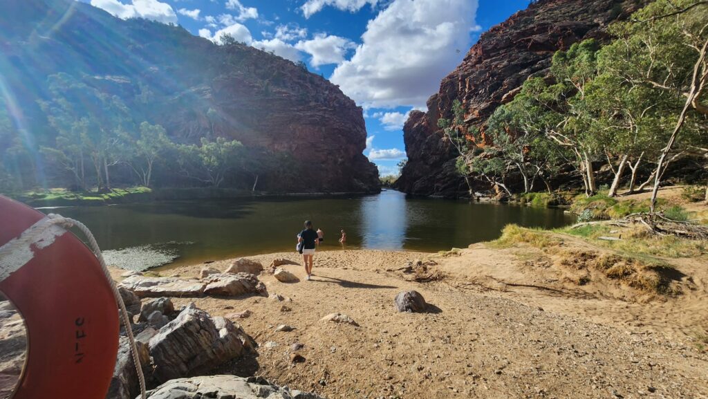 Watering hole with some people swimming in it