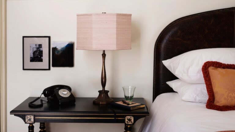 A bed and side table at NoMad London