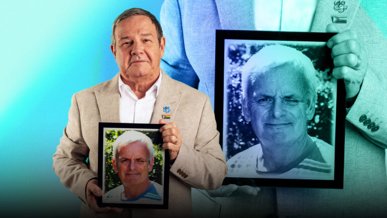 Mike Parish holding up a picture of his husband Tom