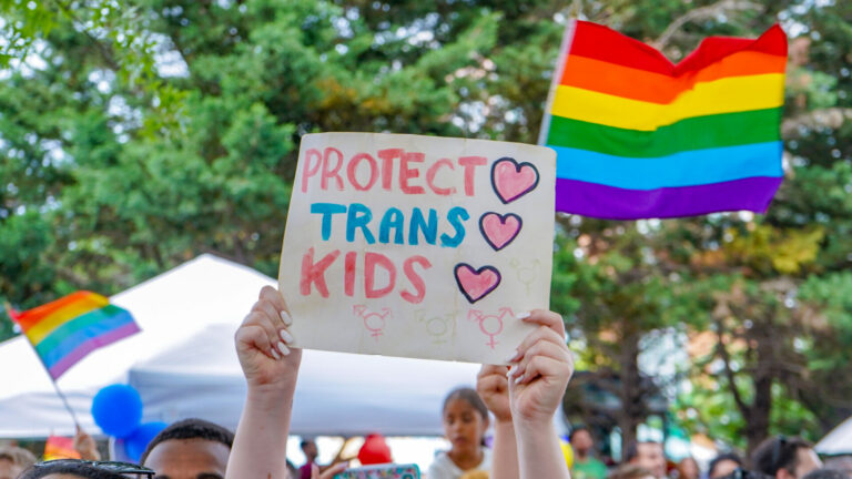 A sign reading "protect trans kids" at the 2018 Capital Pride Parade in Washington, D.C.