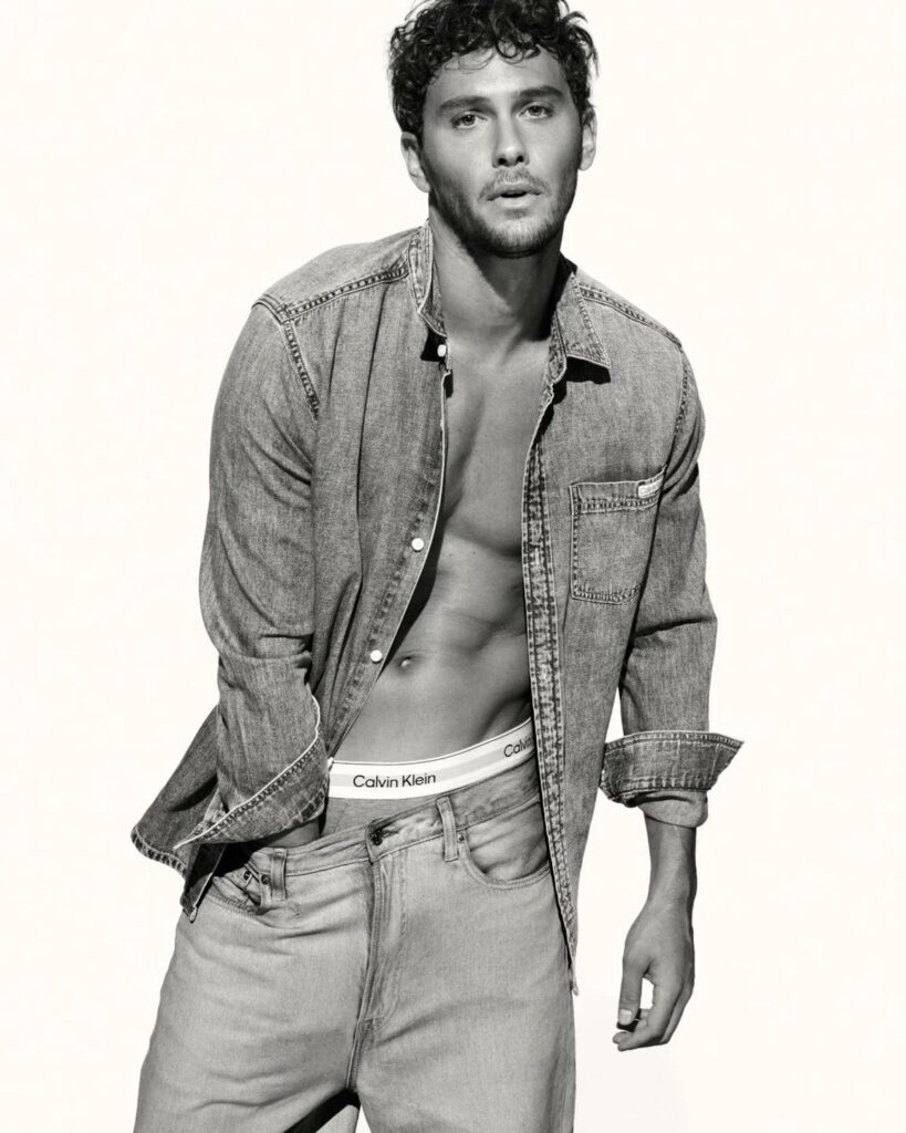Cooper Koch in a denim shirt, underwear and jeans with hand down trousers