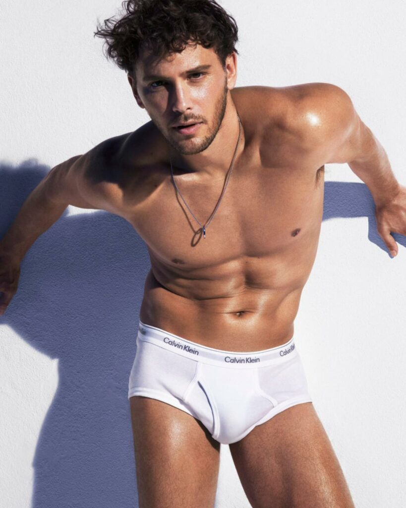 Cooper in white underwear before a white backdrop