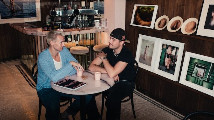 Two men sitting in the BOYS! BOYS! BOYS! Gallery Café