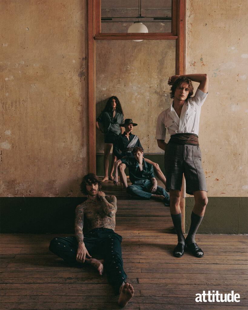 Five models pose against limestone wash wall and door frame in a mix of linen shirts, shorts and trousers