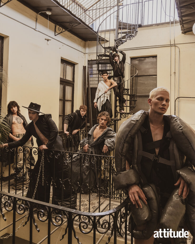 Seven models pose in different positions in a stairway in a variety of structured tailored looks