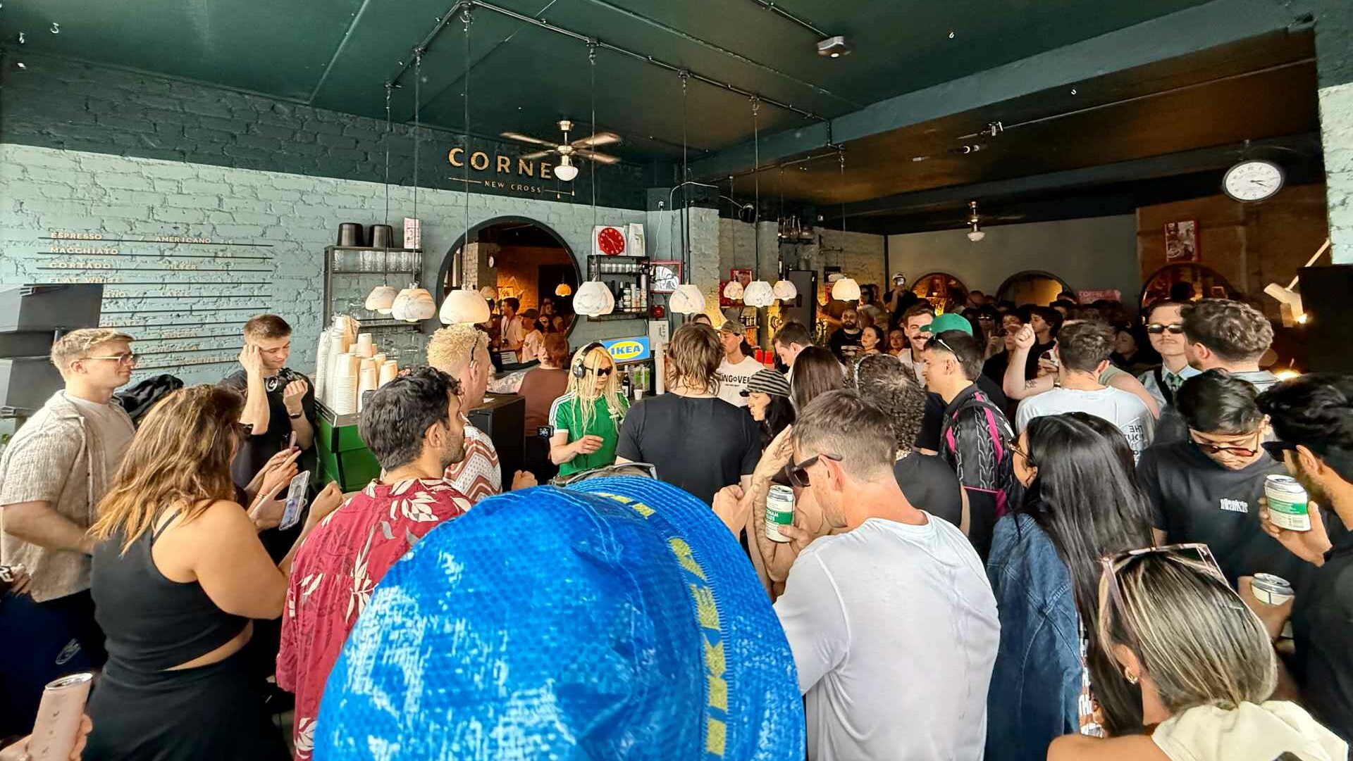 Bimini DJing in a packed café while the crowd watches