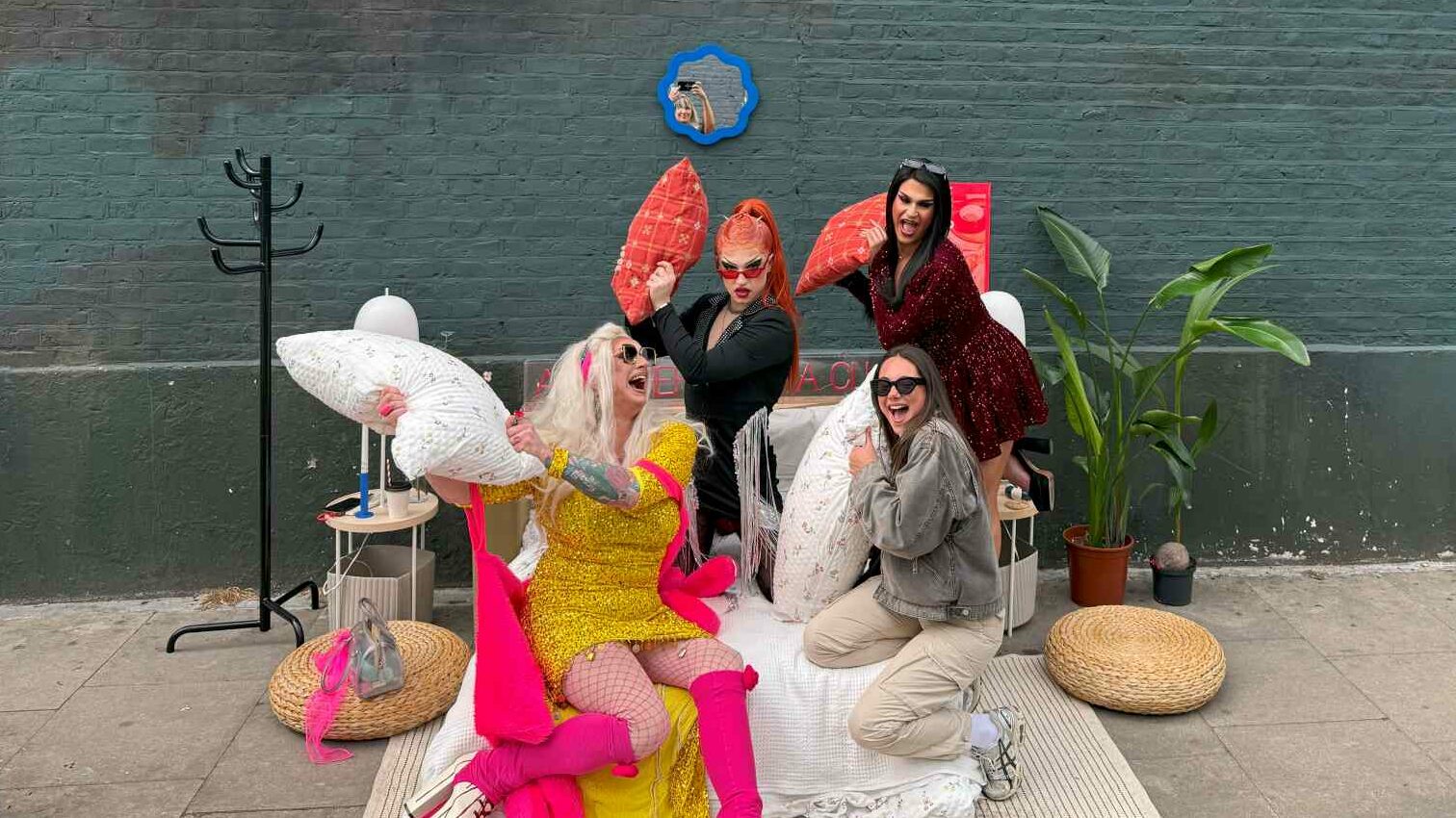 A group of people have a pretend pillow fight on the street in East London