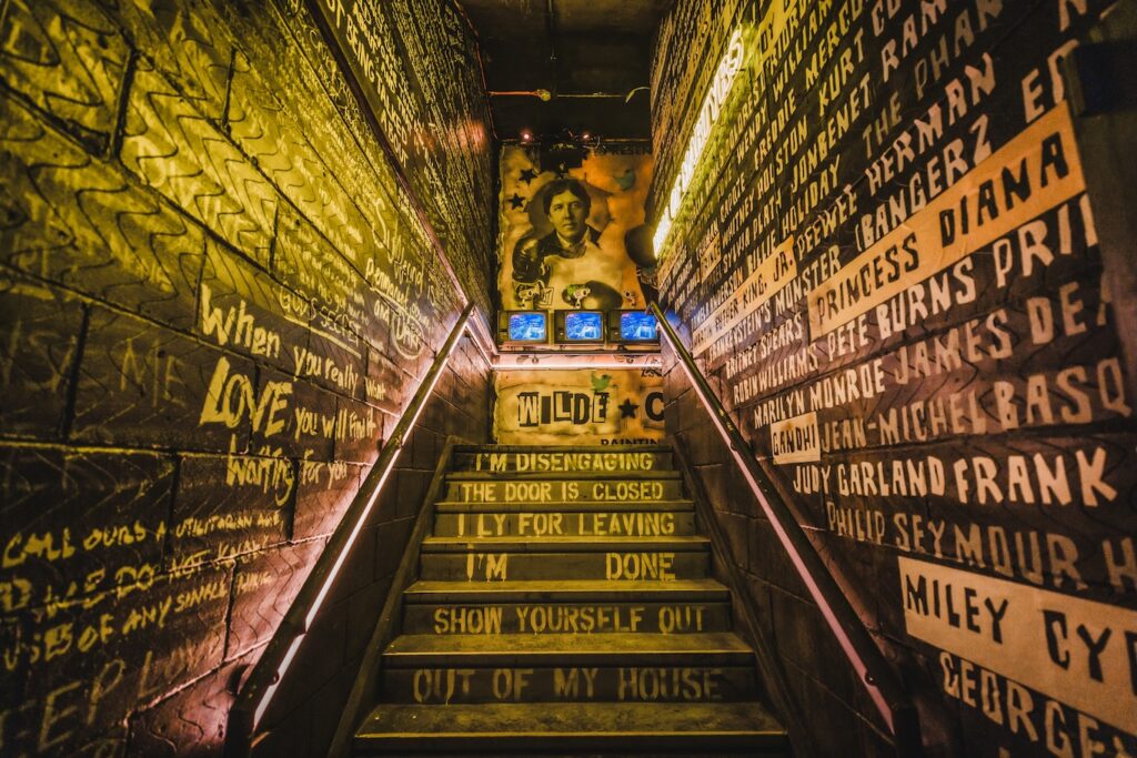a staircase with yellow writing on walls