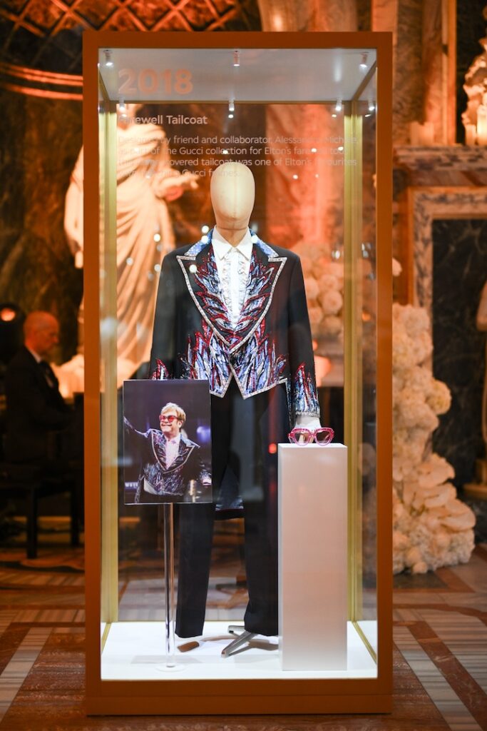 One of Elton's old stage outfits on display at the event, a black jacket with blue flame trim, in a glass case