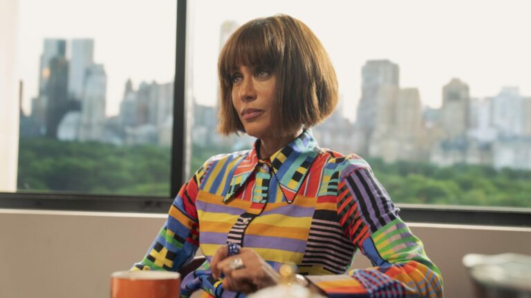 Nicole Ari Parker as Lisa in And Just Like That... in a colourful top with npc skyline behind her