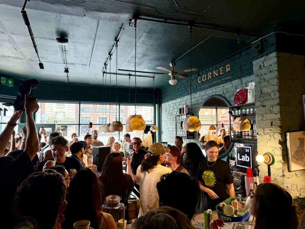 Gok Wan DJs to a busy crowd inside an East London bar