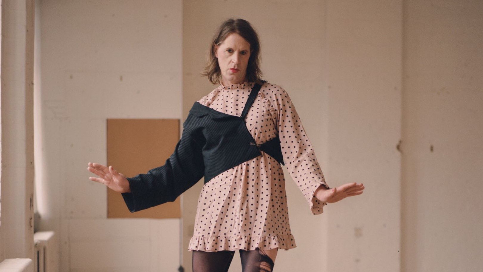 Grace Sands in a pink dress with a black arm element