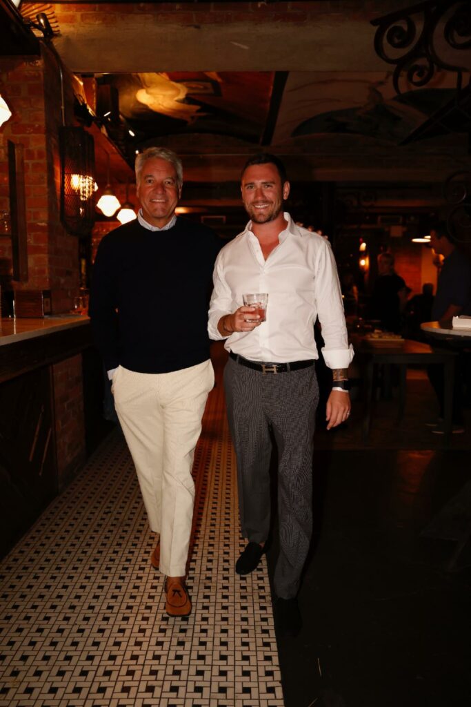 Andy and his partner standing in a bar