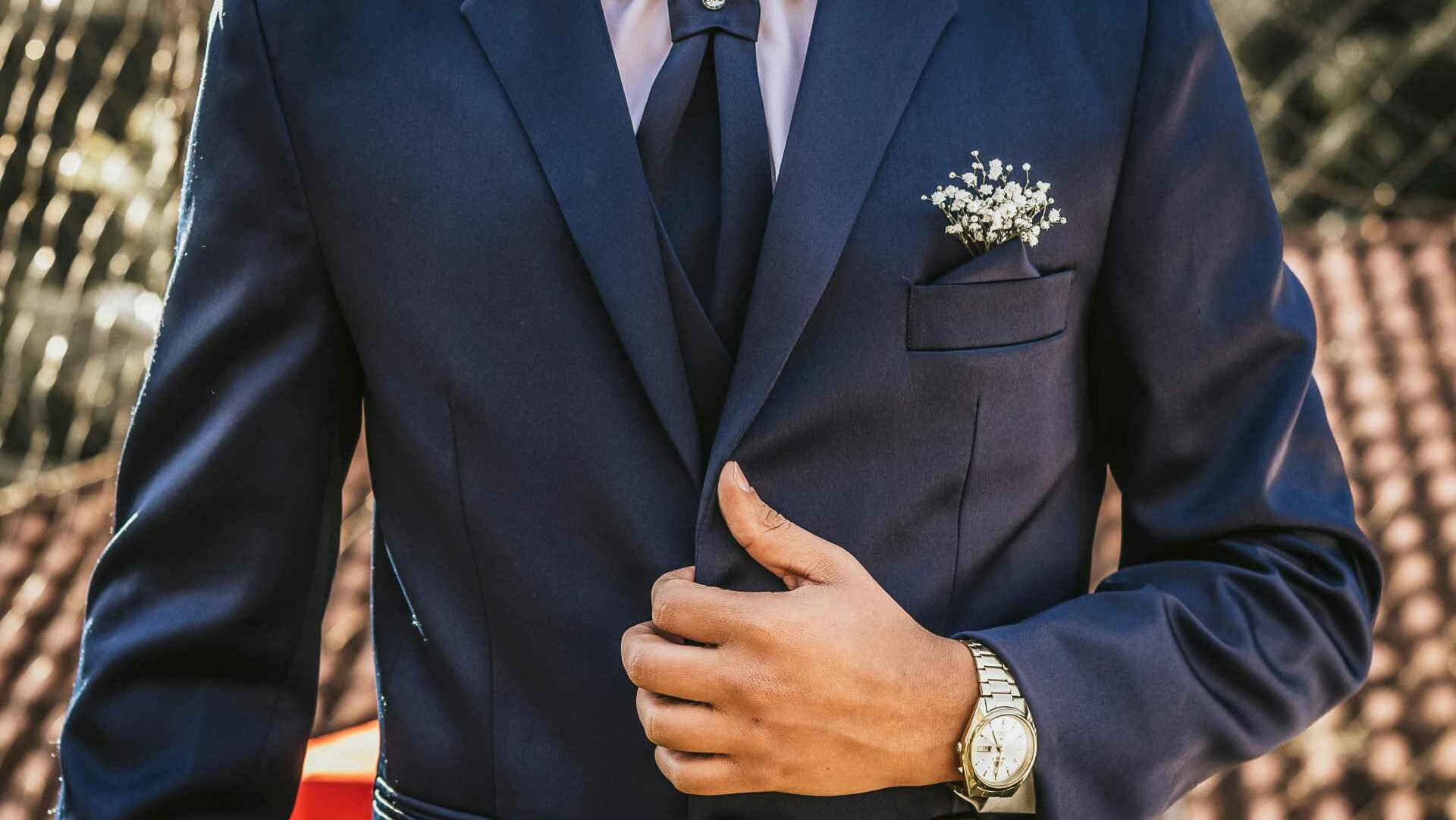 Close ctop of a man wearing a blue wedding suit