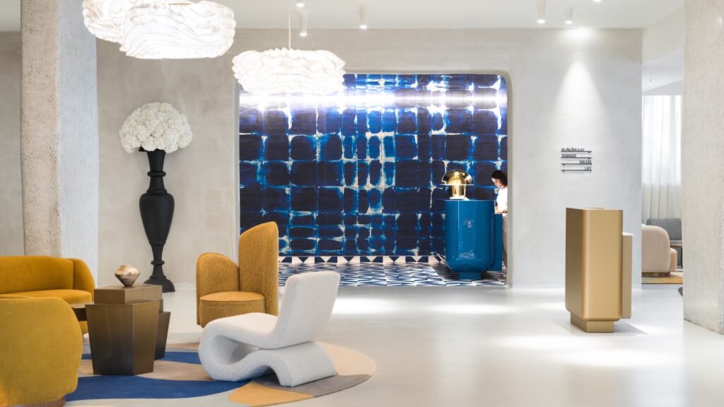 a photograph of the reception area ion the hotel, white floors and walls