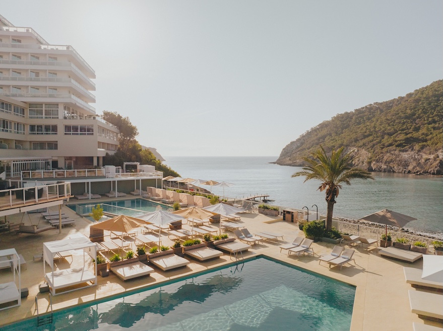 exterior shot of the pool, with the sea and coastline in the shot