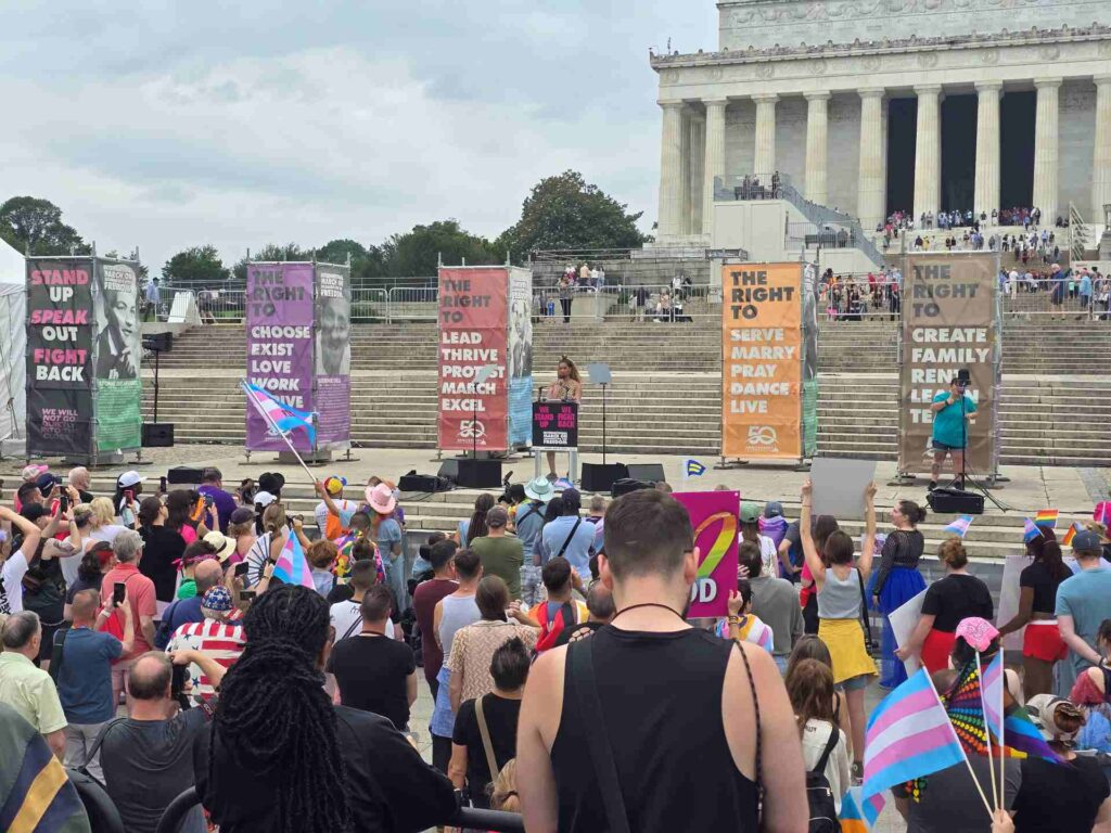 A speaker talks at a rally on the steps of the Lincoln Memorial