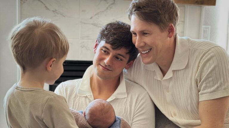 Tom Daley and Dustin Lance Black looking at their children