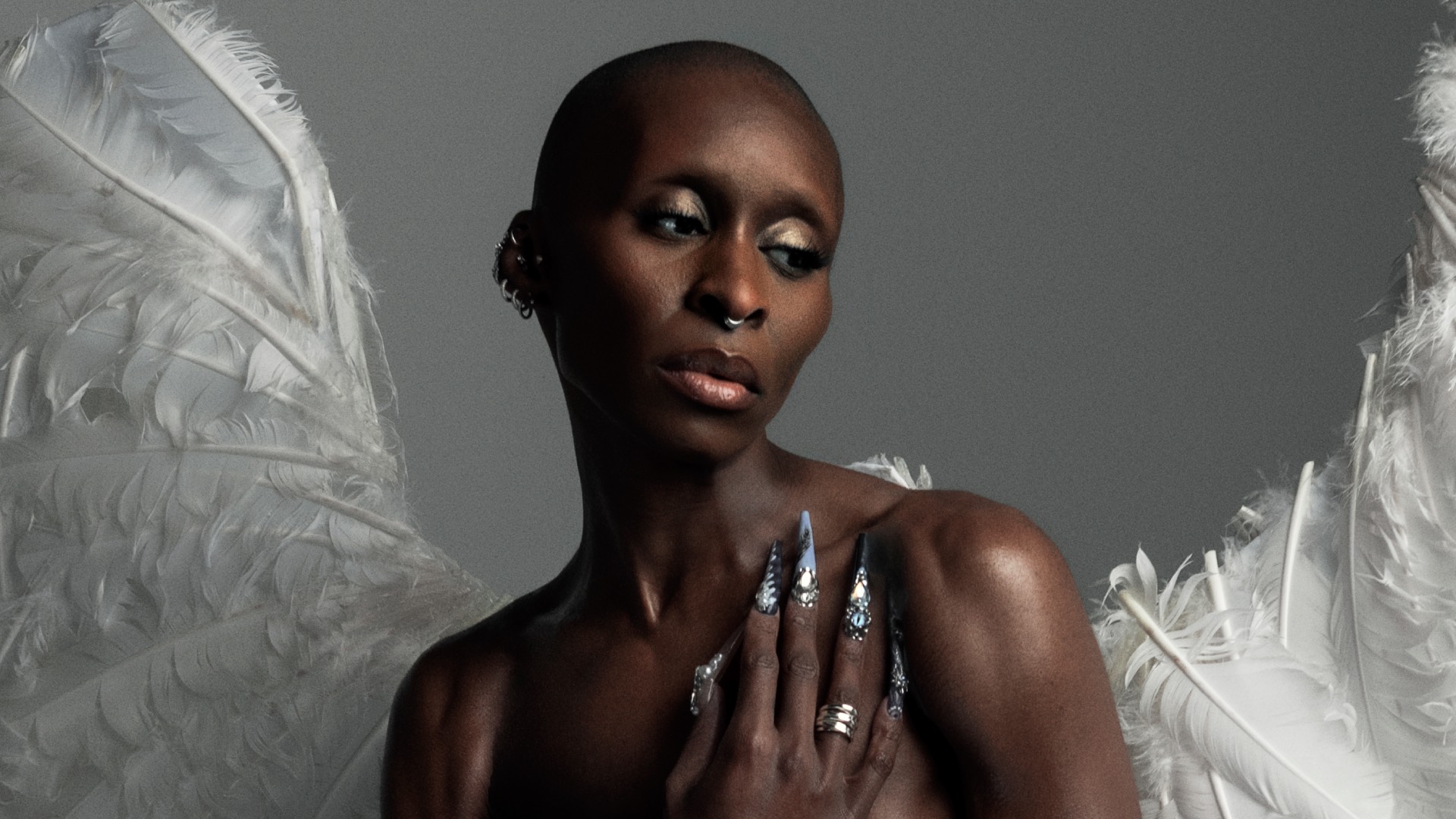 Cynthia Erivo in the album artwork for I Forgive You, topless and wearing angel wings