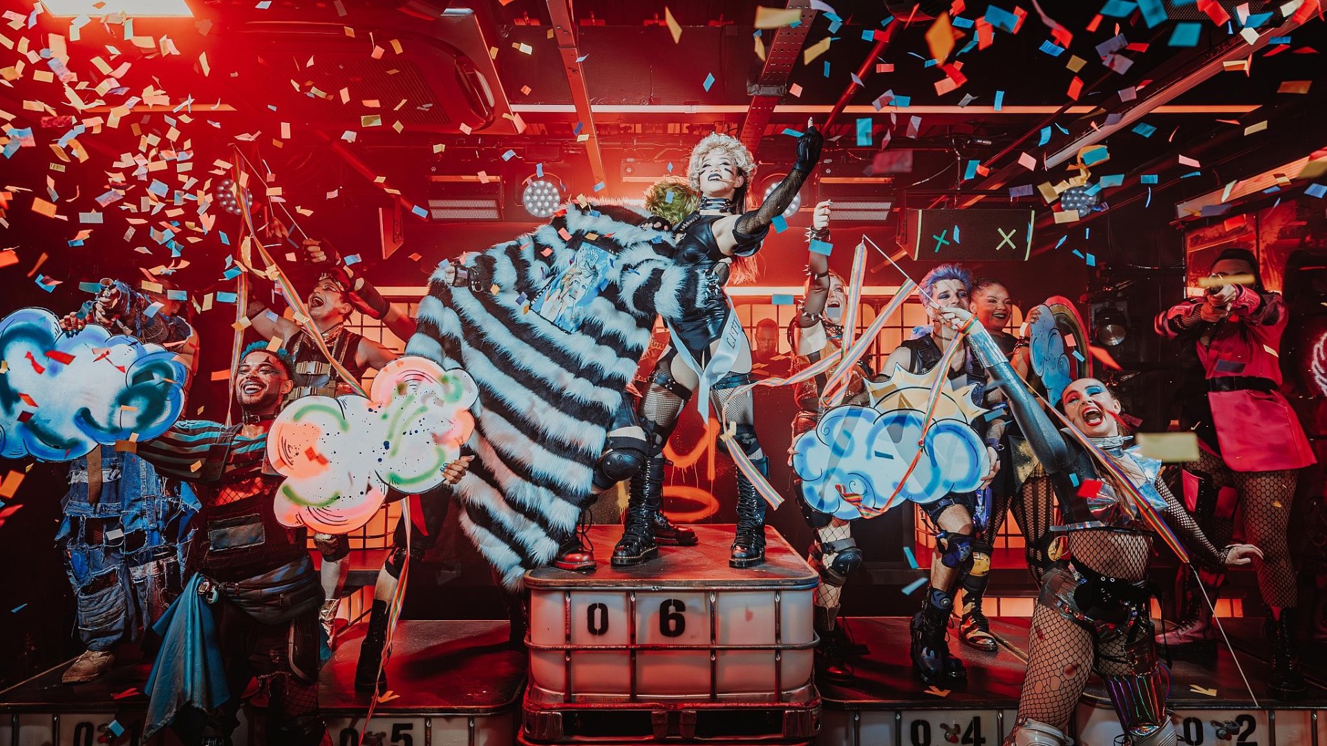 Performers on stage at Oscar at the Crown, with confetti falling
