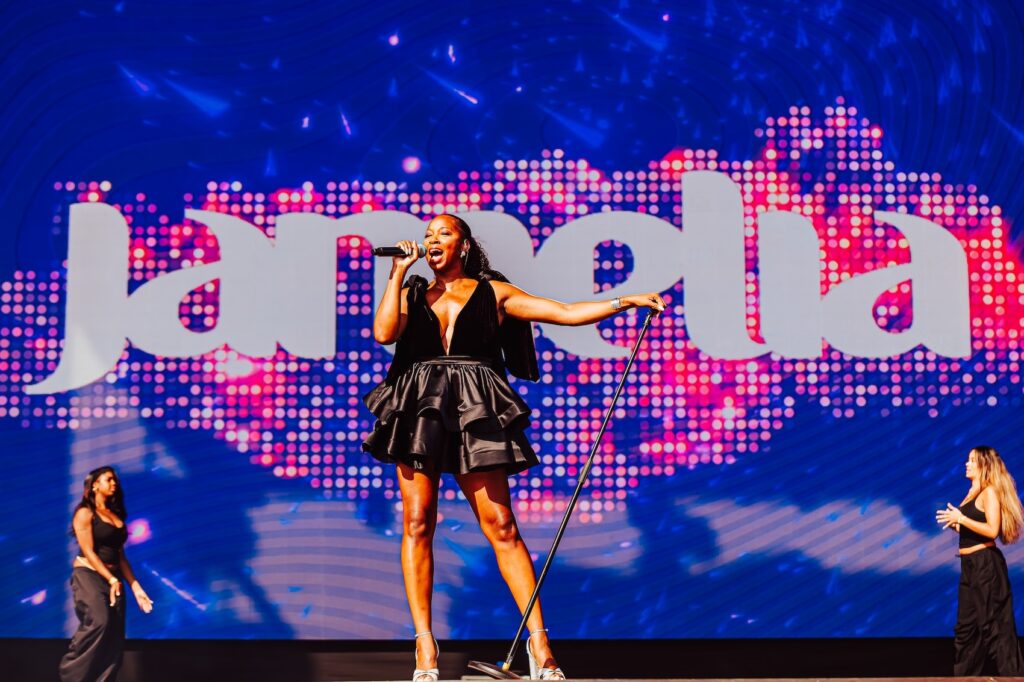 Jamelia on stage in a black dress