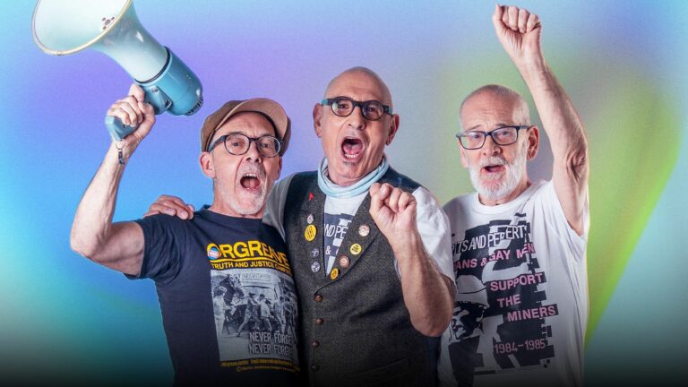 Mike Jackson, Jonathan Blake and Gethin Roberts of LGSM against a colourful gradient backdrop
