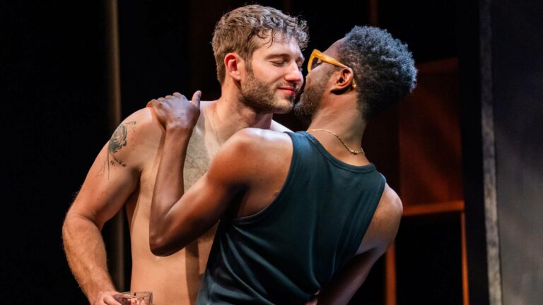 Alexander Lincoln and Omari Douglas embrace eachother on stage at This Bitter Earth