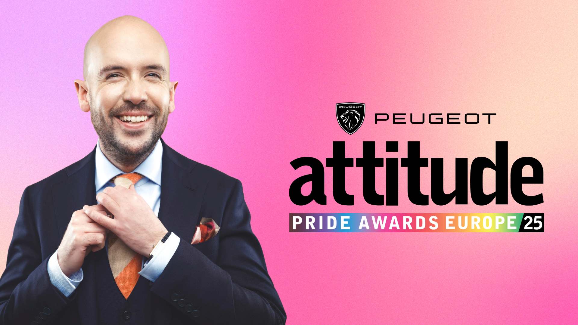 Tom Allen wearing a suit in smiling against a pink backdrop with the Peugeot Attitude Pride Awards Europe logo in the background