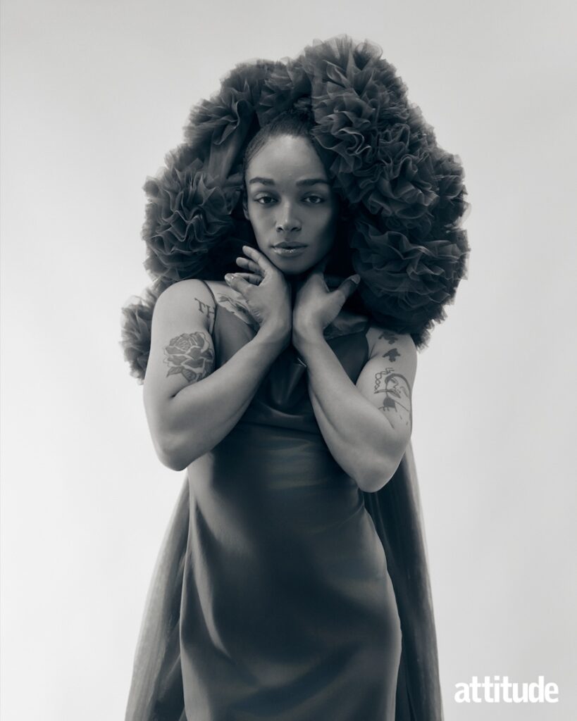 black and white shot of Alex Thomas-Smith in a satin dress and tulle headpiece