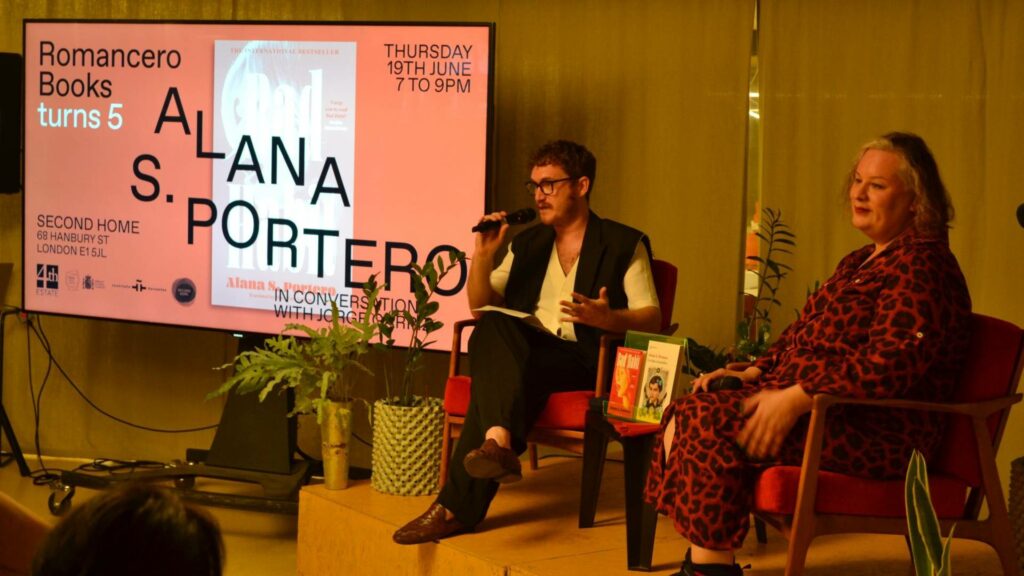 Alana S. Portero and Jorge Garriz sat down on red chairs at Second Home, in conversation with the audience at the Romancero Books Fifth Anniversary event, celebrating the launch of the paperback edition of Bad Habit