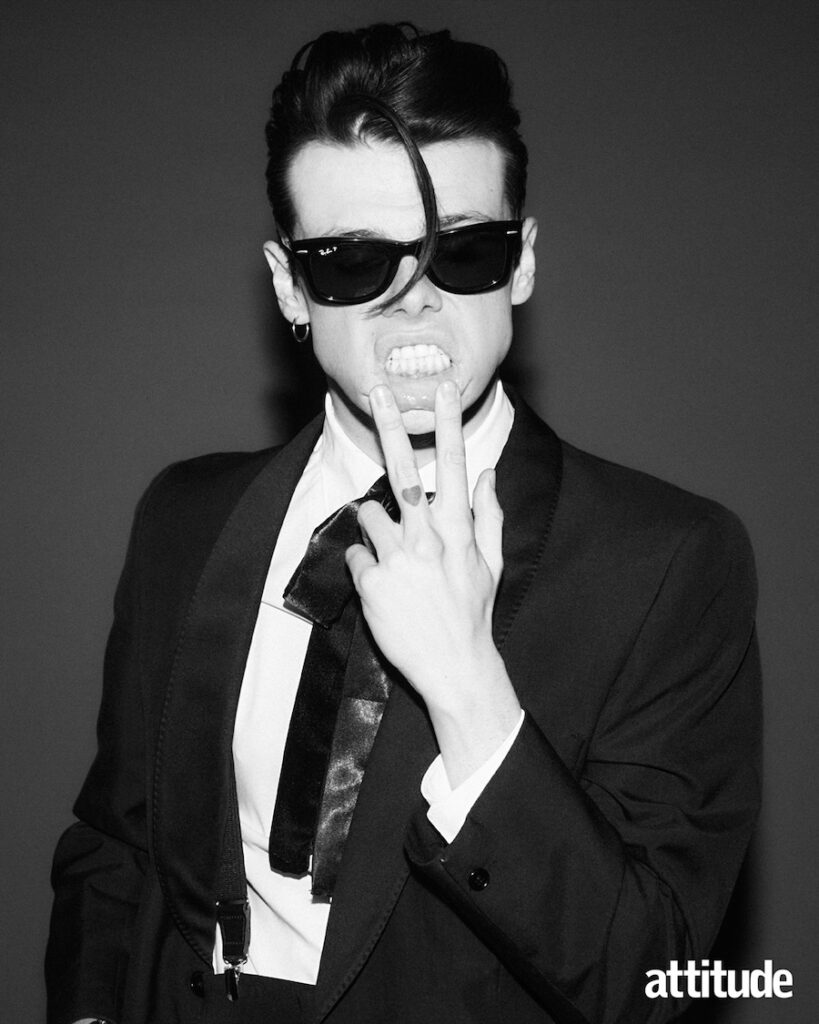 in sunglasses, blazer and white shirt, wearing black sunglasses